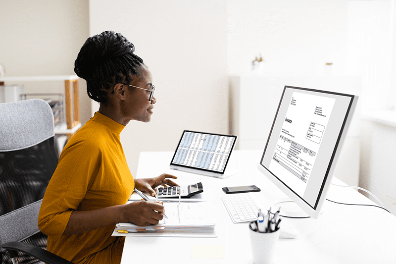 Business woman paying invoices to help build business credit