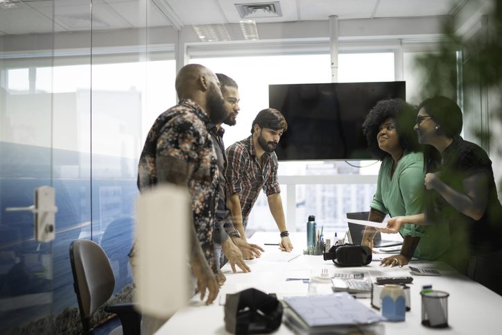 Diverse business team meets in conference room to discuss business planning and financial statements