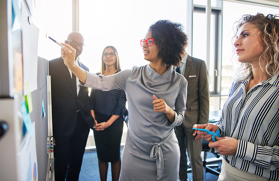 African American woman presenting information in a diverse business setting