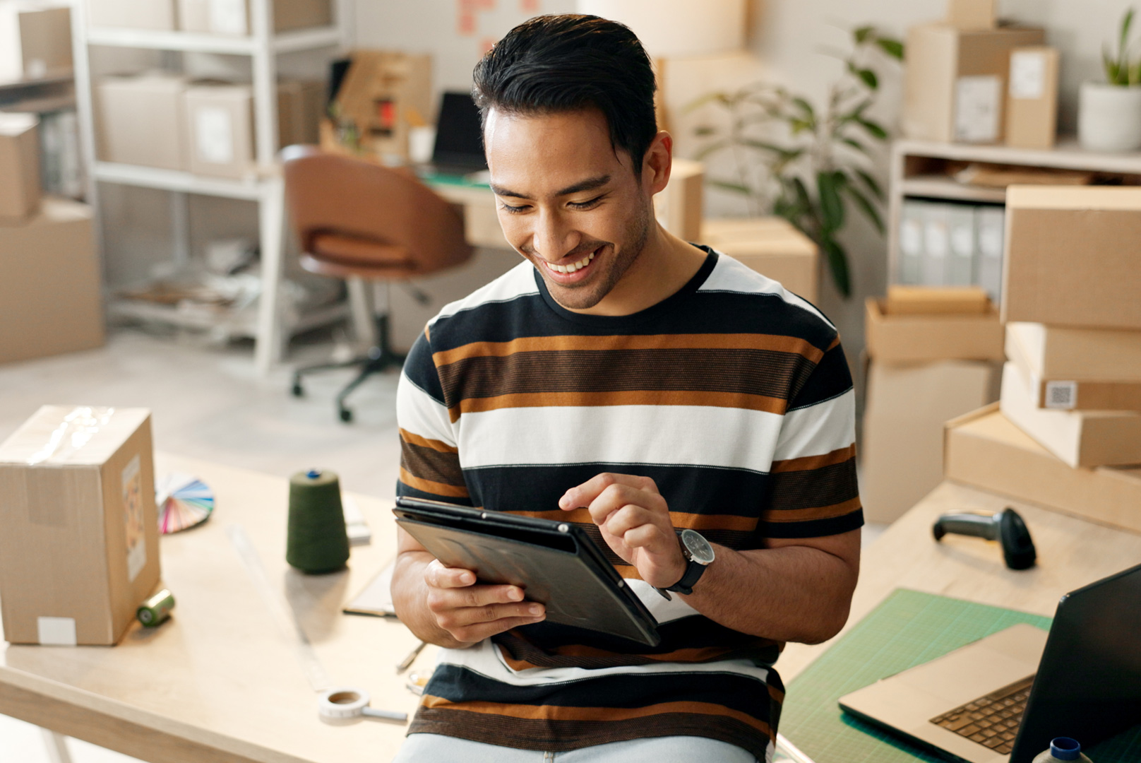 Small business, man and boxes with tablet for e commerce and startup inventory with online shop,order or office courier. Entrepreneur or happy seller with digital technology for logistics and package