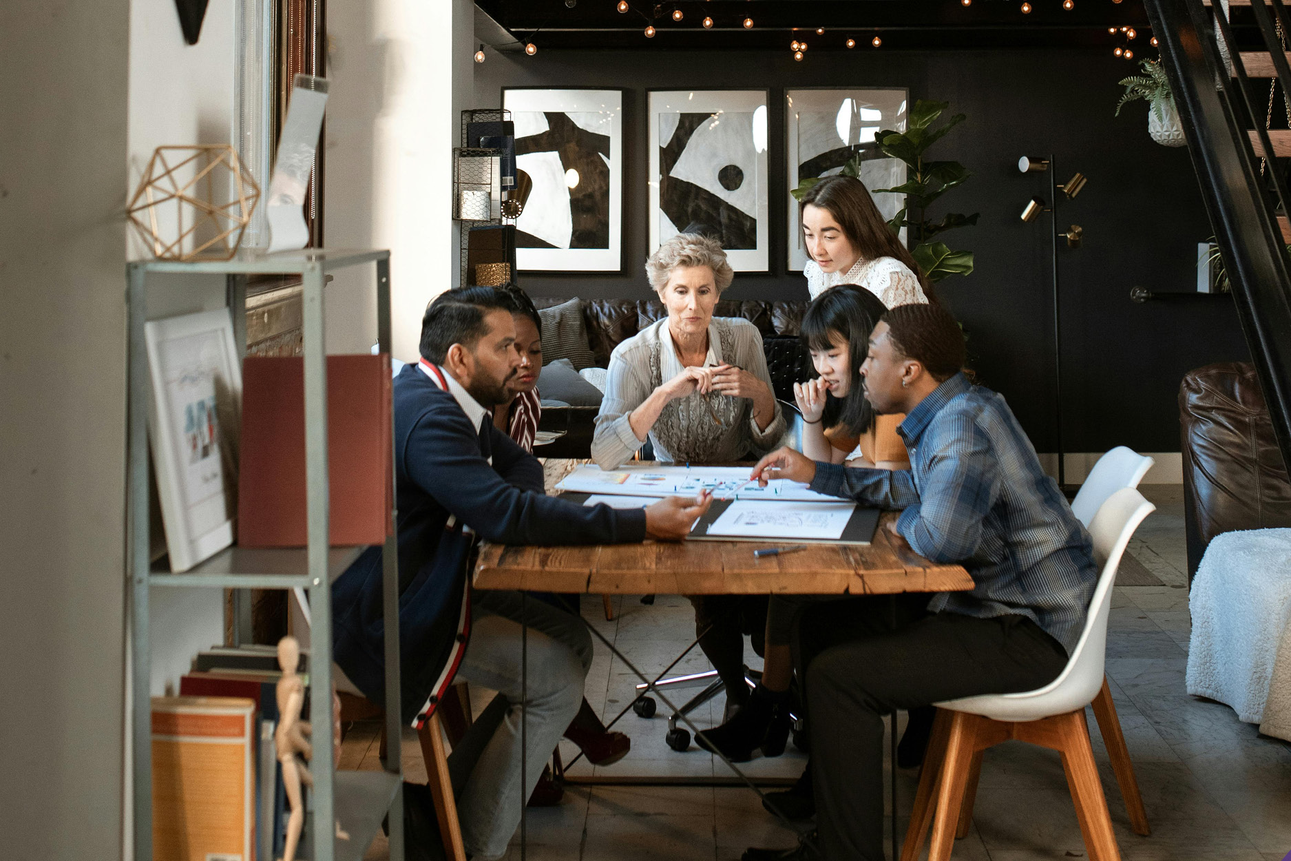 Diverse group of business partners meeting and discussing their business loan options