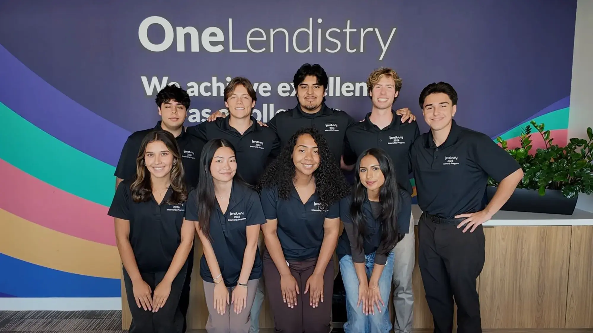 Group photo of Lendistry's 2026 Internships standing in front of the One Lendistry wall.