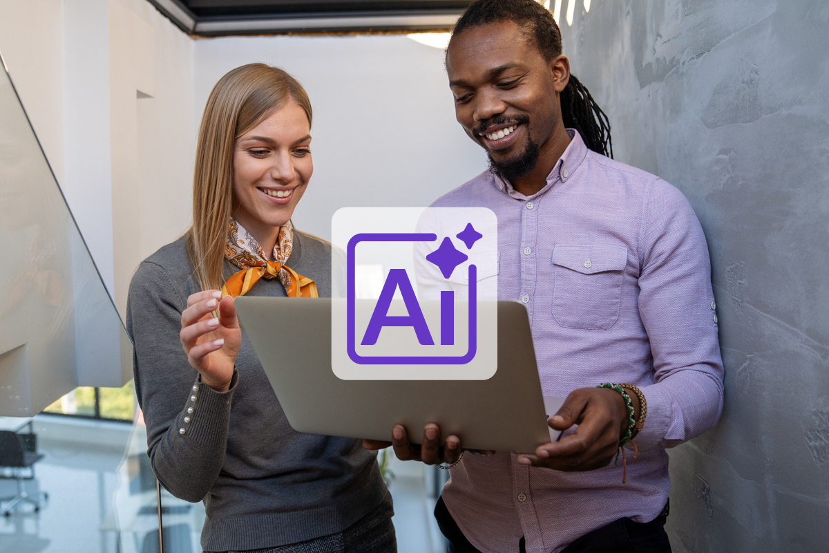 Two business associates smiling while looking at a laptop and discussing generative Ai for their small business