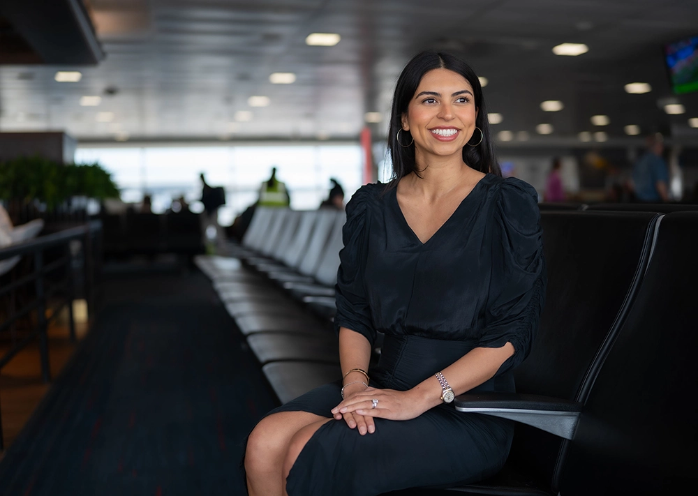 Samantha Sanchez of Samantha Alexis Consulting sitting at an airport lounge