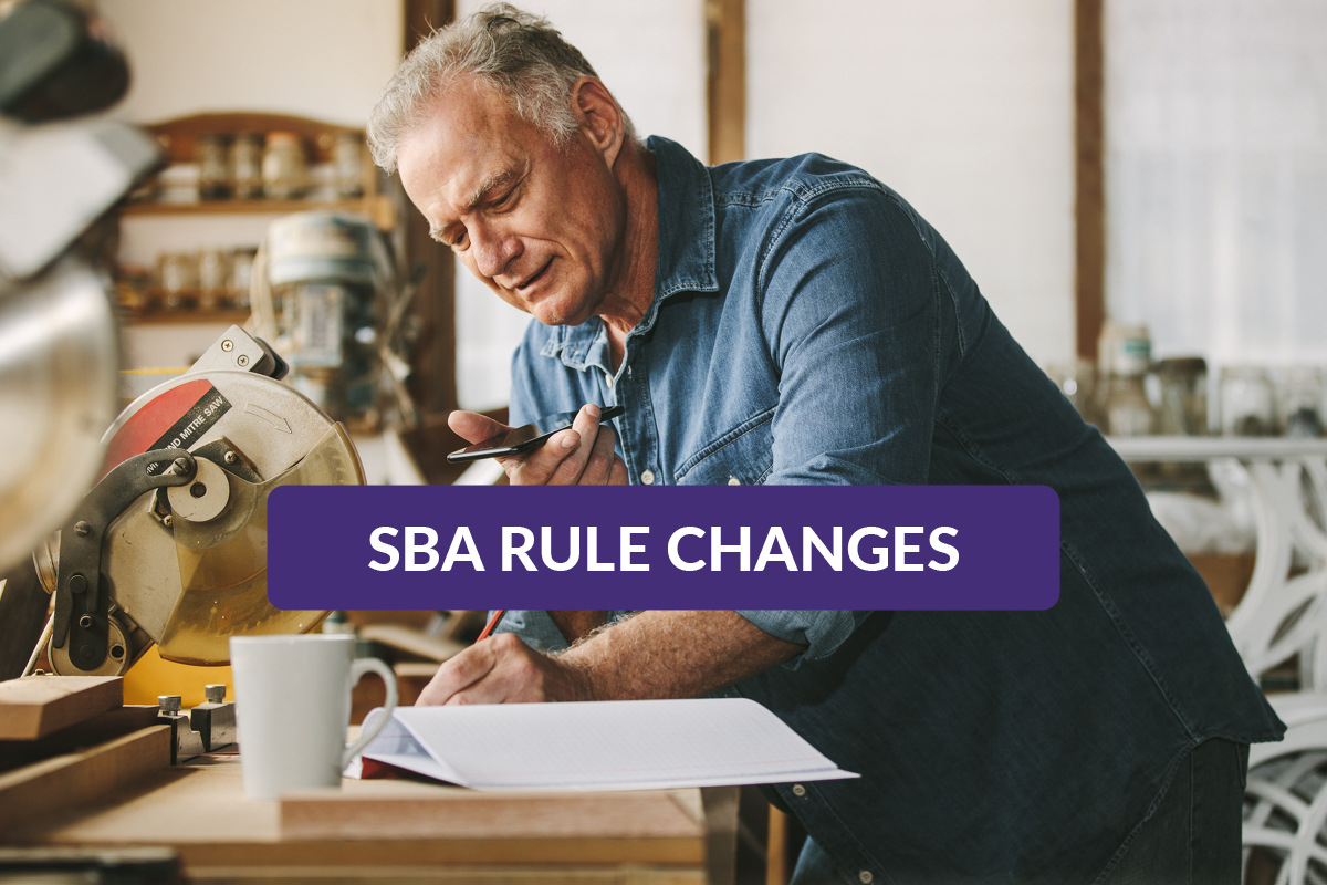 Senior business owner talking on the phone and taking notes on the new SBA Business Acquisition changes